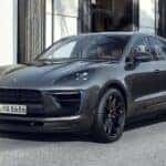 2025 Porsche Macan parked on a stylish city street, showcasing its sleek design and luxury SUV features