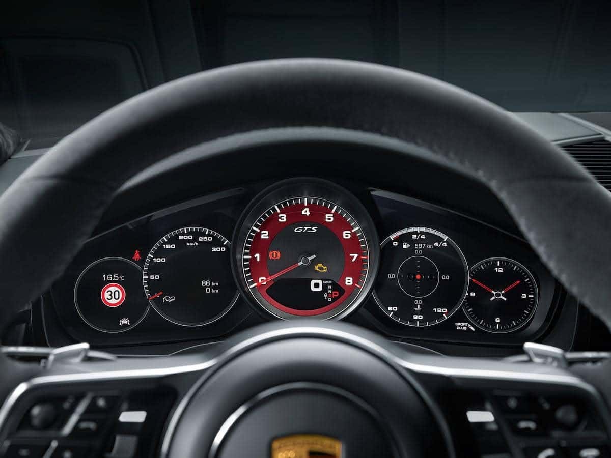 Close-up view of the Porsche Macan advanced dashboard display, highlighting the sporty GTS tachometer and digital controls.
