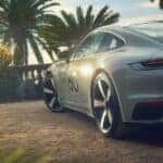 Rear view of Porsche 911 Sport Classic parked in a scenic garden setting, highlighting the iconic ducktail spoiler and retro-inspired design