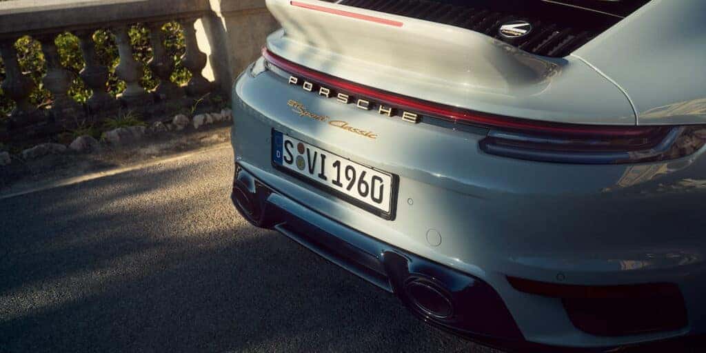 Close-up of the rear badge and license plate of the Porsche 911 Sport Classic, showcasing the "Sport Classic" gold emblem and distinctive tail design.