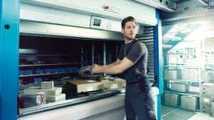 A Certified Porsche Technician pulls parts from the onsite parts department.