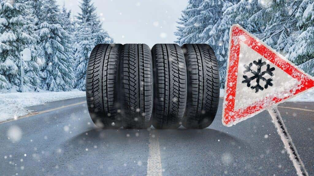 winter landscape with asphalt road. Winter - time to change tires on winter tires