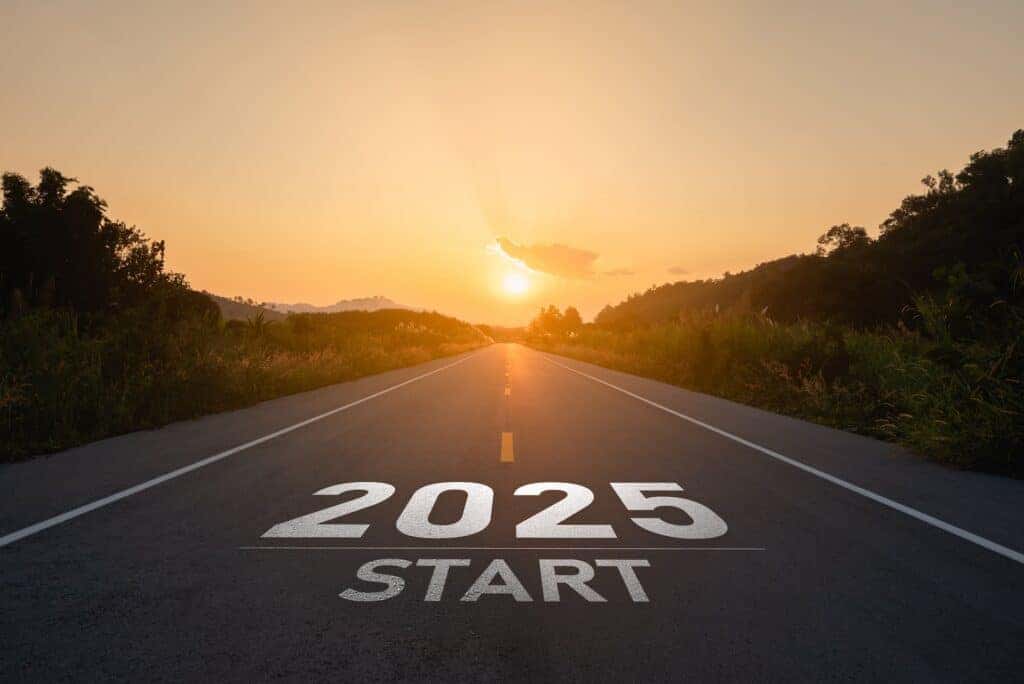 Happy new year 2025,2025 symbolizes the start of the new year. The letter start new year 2025 on the road in the nature route roadway sunset tree environment ecology greenery wallpaper concept.