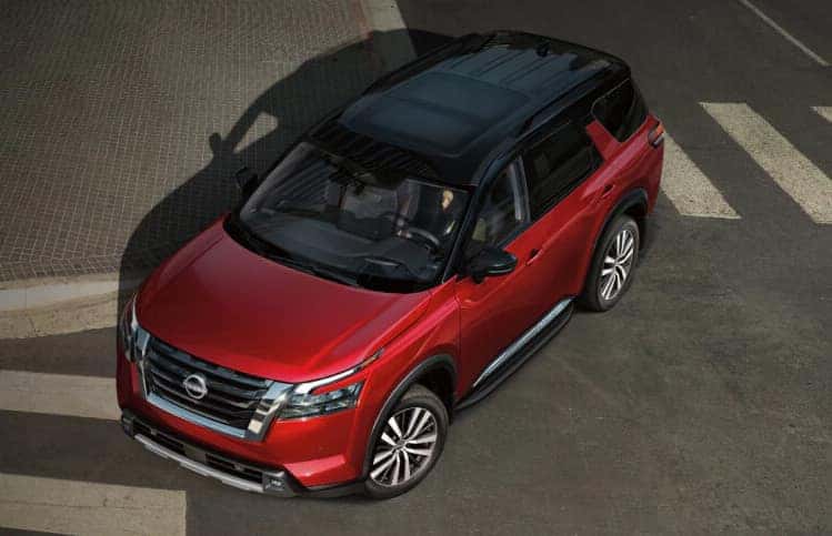 2025 Nissan Pathfinder turning right on city street