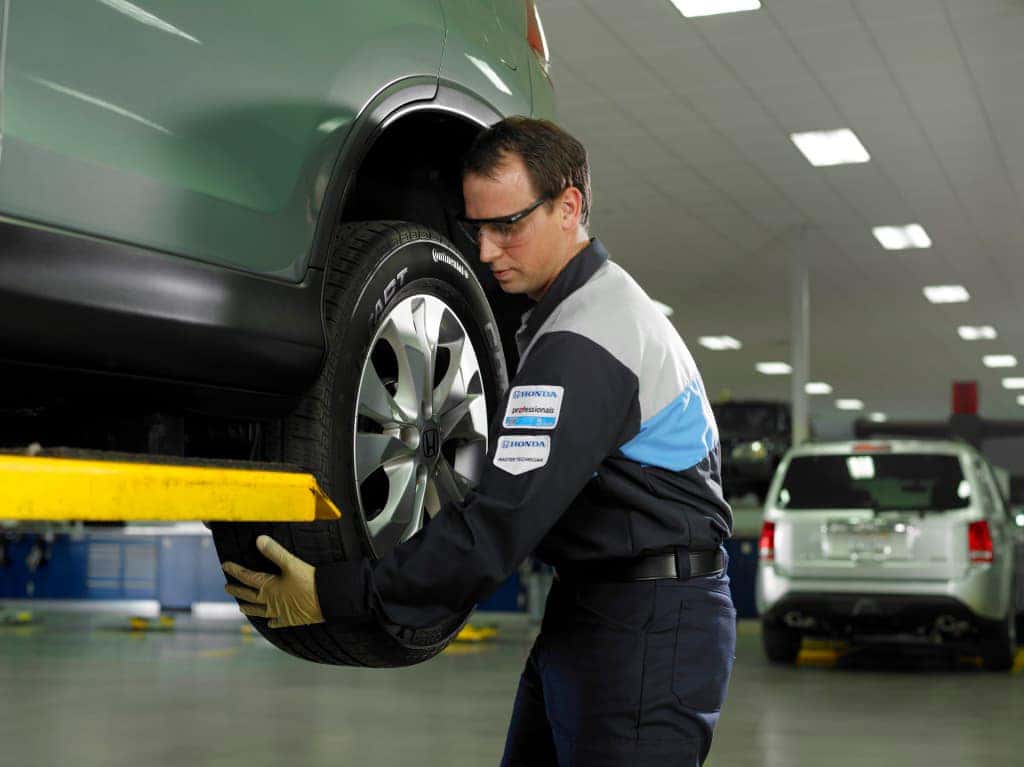 Honda service technician changing a tire