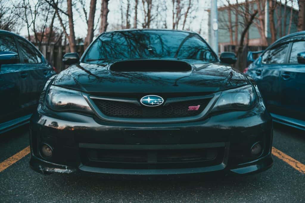 front of a black subaru wrx STI