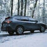 black subaru outback on a snowy trail