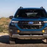 front of a blue 2027 subaru forester hybrid wilderness suv