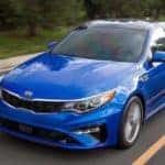Blue 2019 Kia Optima Driving on Highway