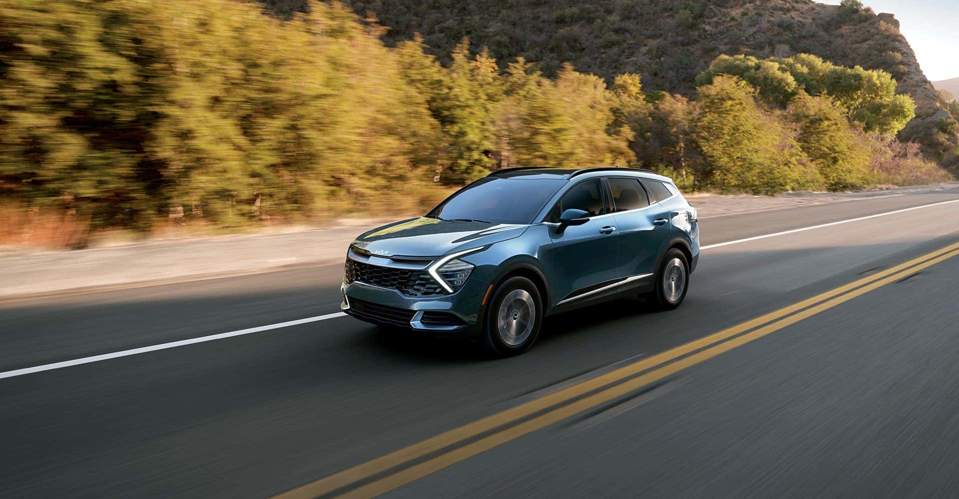 driving desert road Kia Sportage