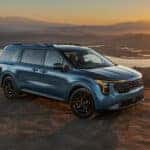 2026 Kia Carnival Hybrid in blue during sunset or sunrise