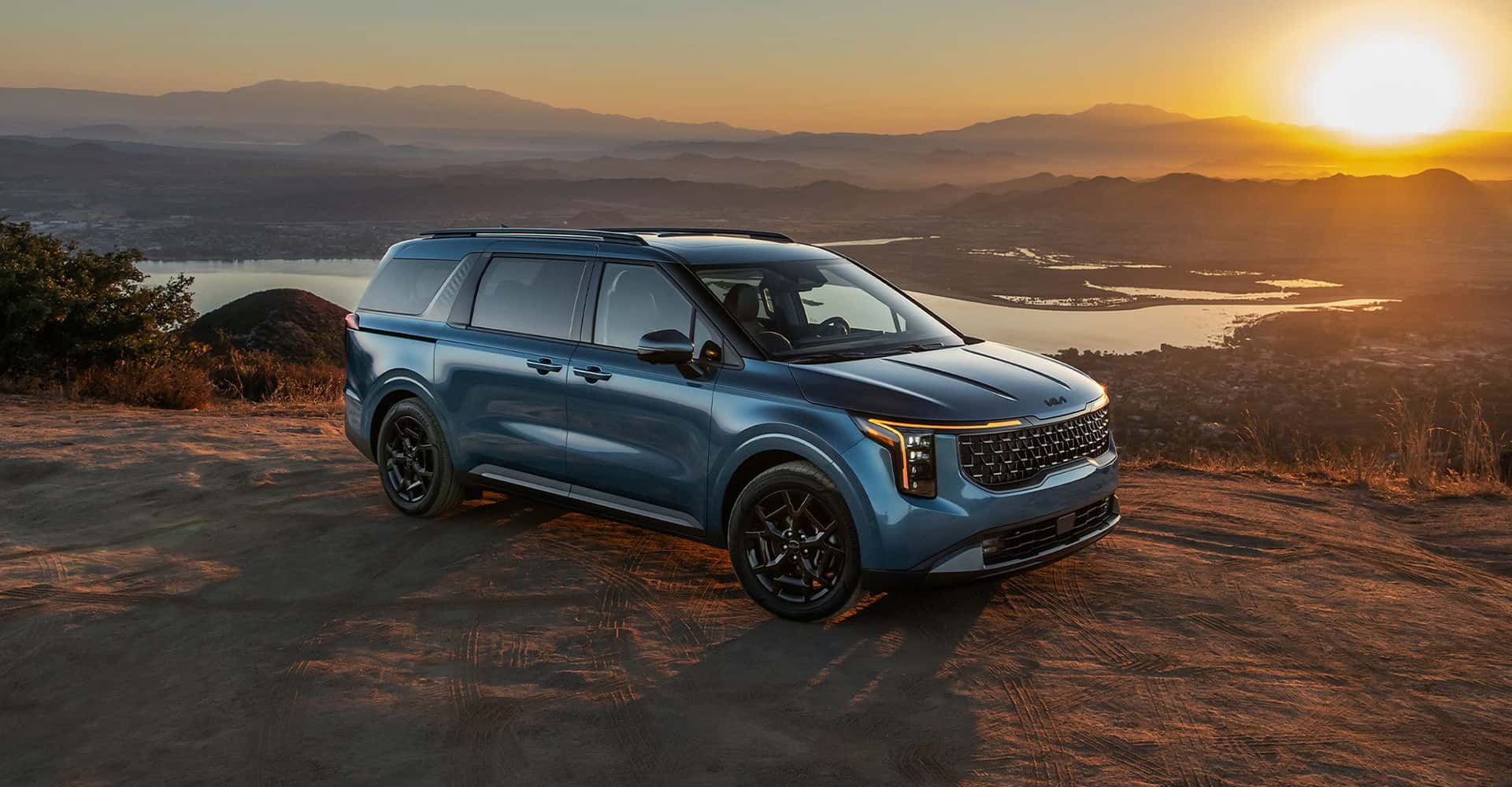 2026 Kia Carnival Hybrid in blue during sunset or sunrise