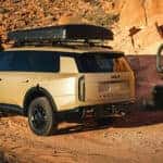 2027 Kia Telluride hauling bike up dirt road