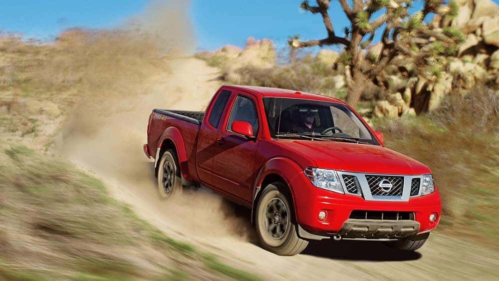 2019 Nissan Frontier Red driving down a dirt road