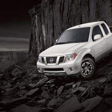2019 Nissan Frontier White driving down a steep rocky hill