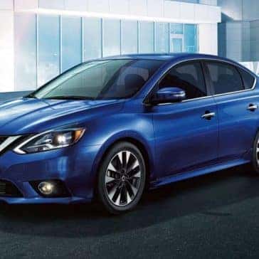 Blue 2019 Nissan Sentra in front of a building in the city