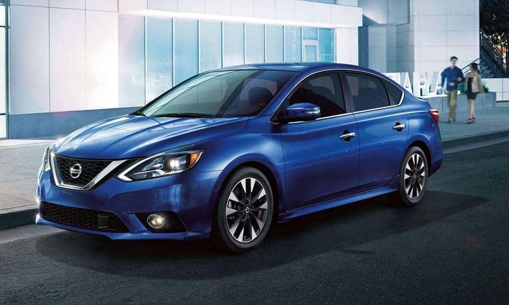 Blue 2019 Nissan Sentra in front of a building in the city