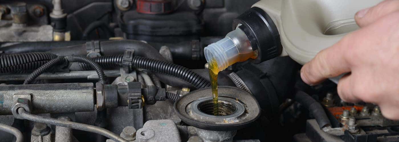 mechanic changing oil in car