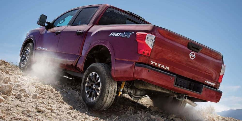 Red 2019 Nissan Titan Climbing Rocks