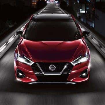2020 Nissan Maxima driving down a city street at night