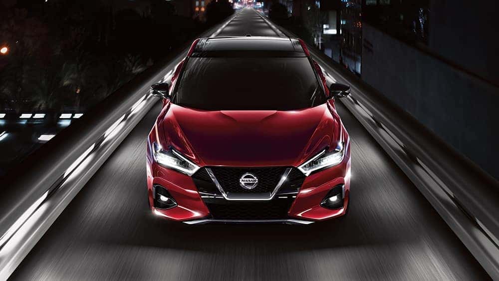 2020 Nissan Maxima driving down a city street at night