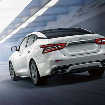 2020 Nissan Maxima driving on a highway rear view