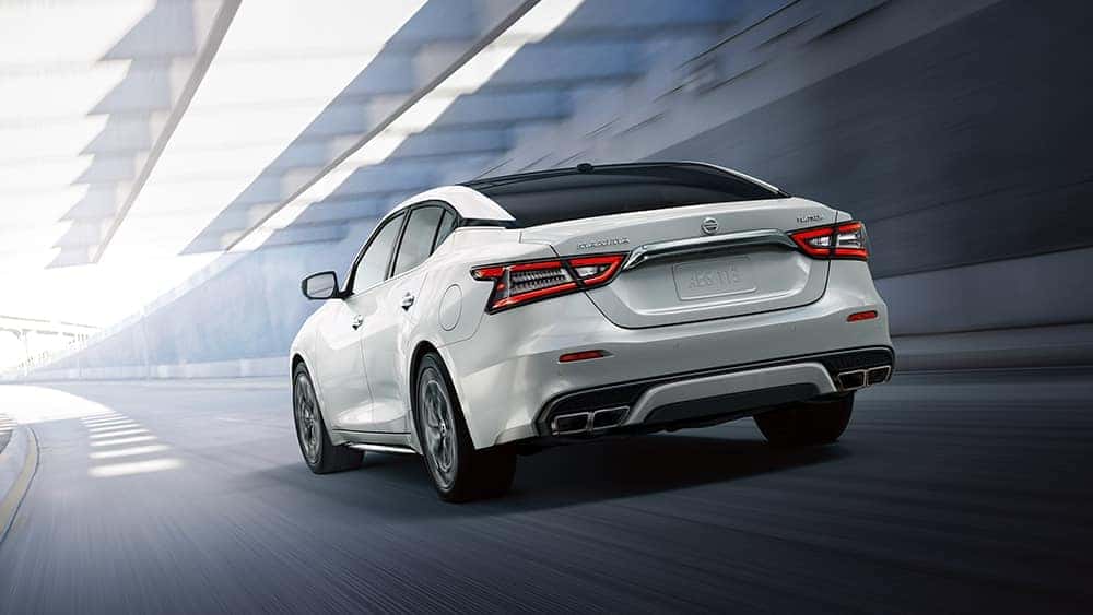 2020 Nissan Maxima driving on a highway rear view