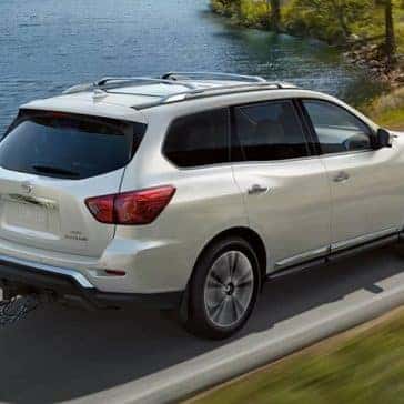 2020 Nissan Pathfinder towing a boat by a lake