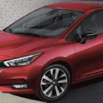 Red 2021 Nissan Versa parked in front of a building