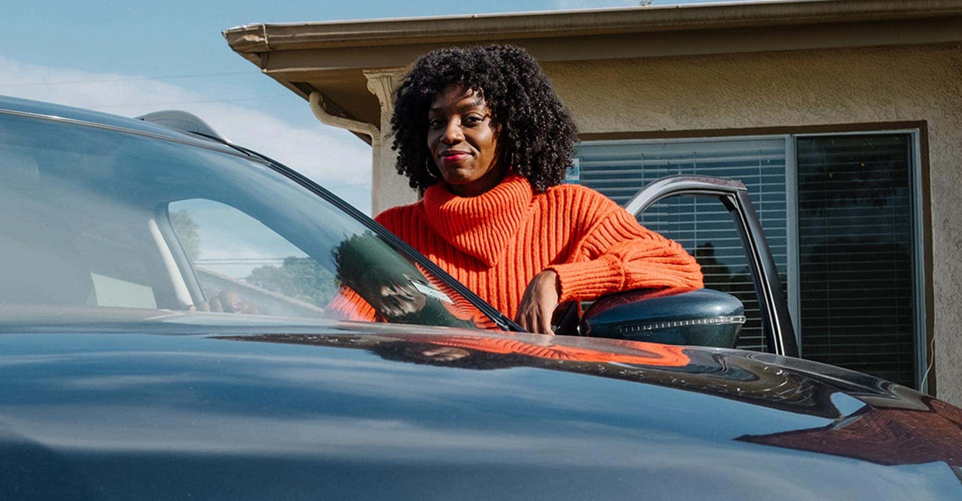 Woman Standing Behind Nissan Rogue