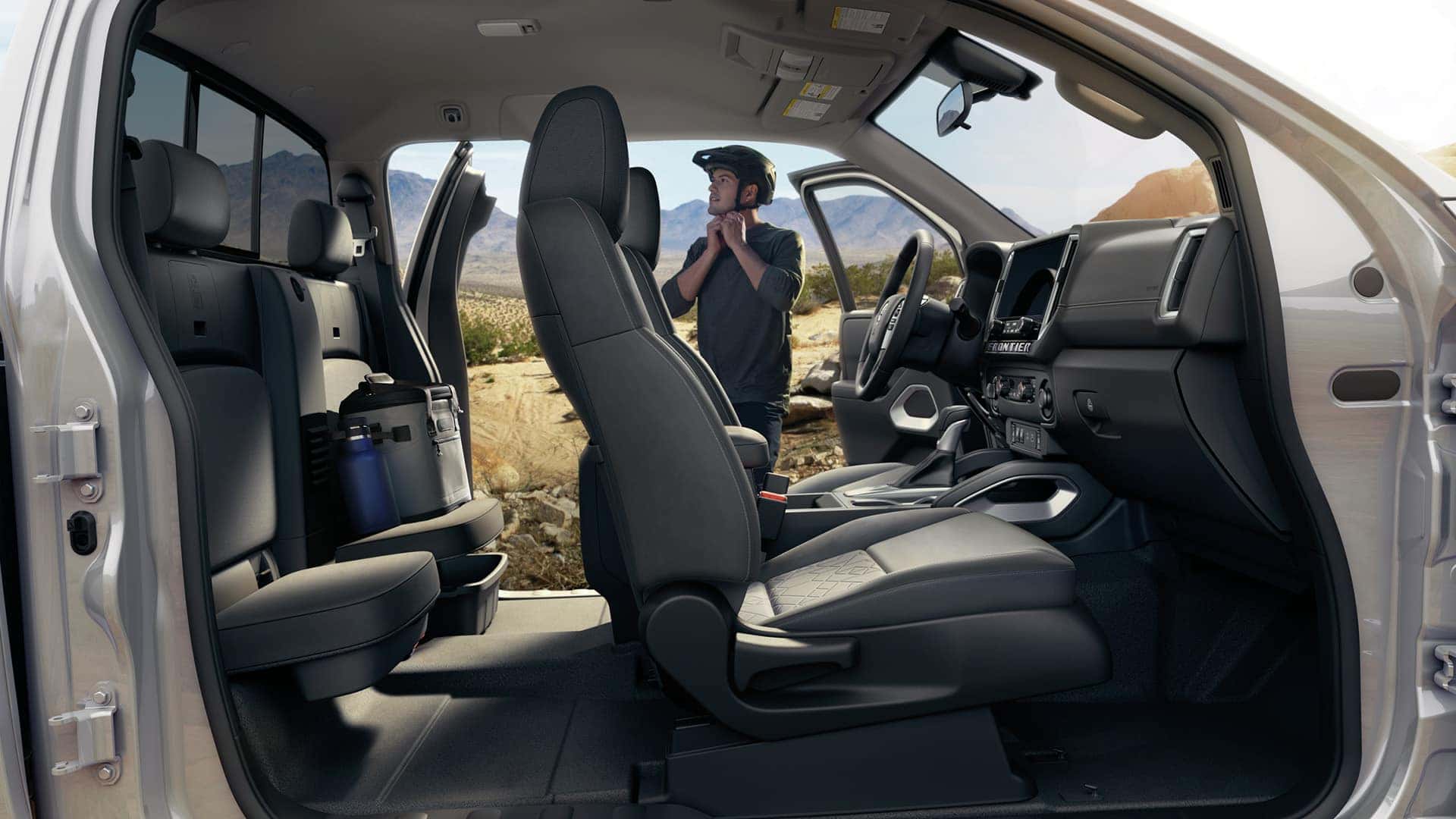 2025 Nissan Frontier Interior with View of Man Putting on Helmet