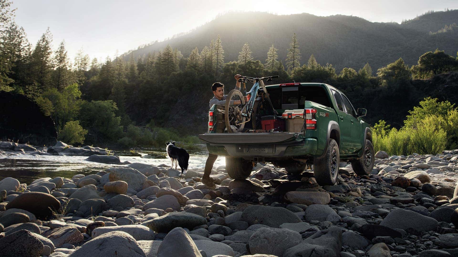 Man Loading Bike into Bed of 2025 Nissan Frontier