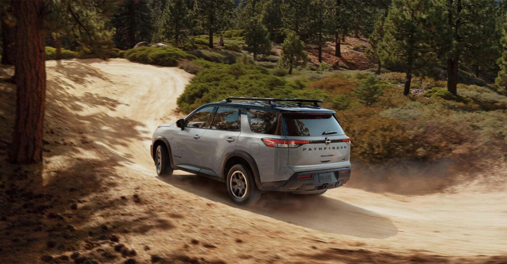 2025-nissan-pathfinder-rear-view-driving-down-dirt-mountain-road
