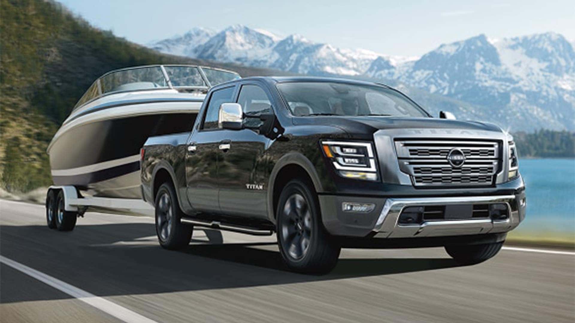 2026 Nissan Titan Towing a Boat on the Road