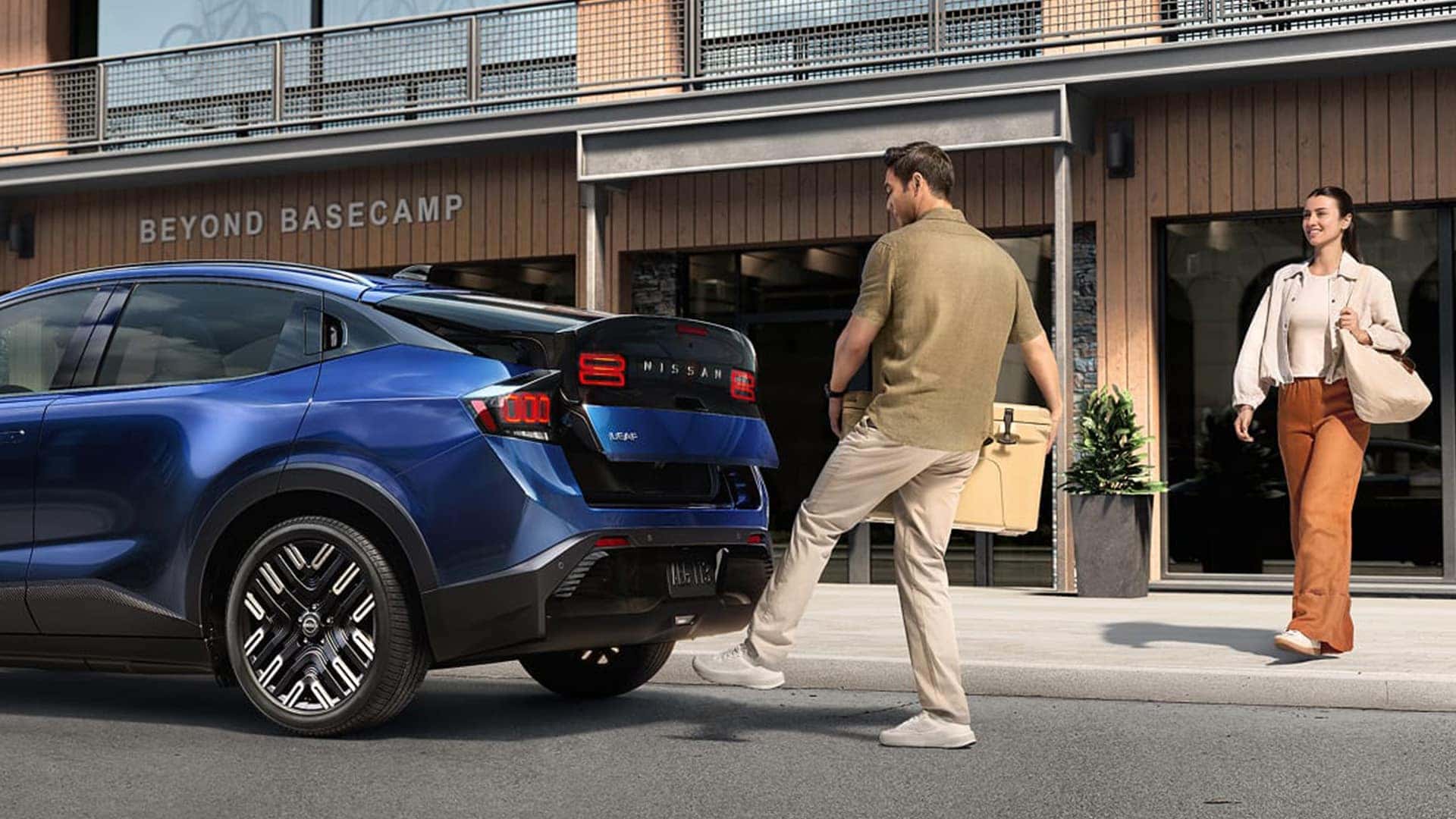 Couple using liftgate on 2026 Nissan LEAF