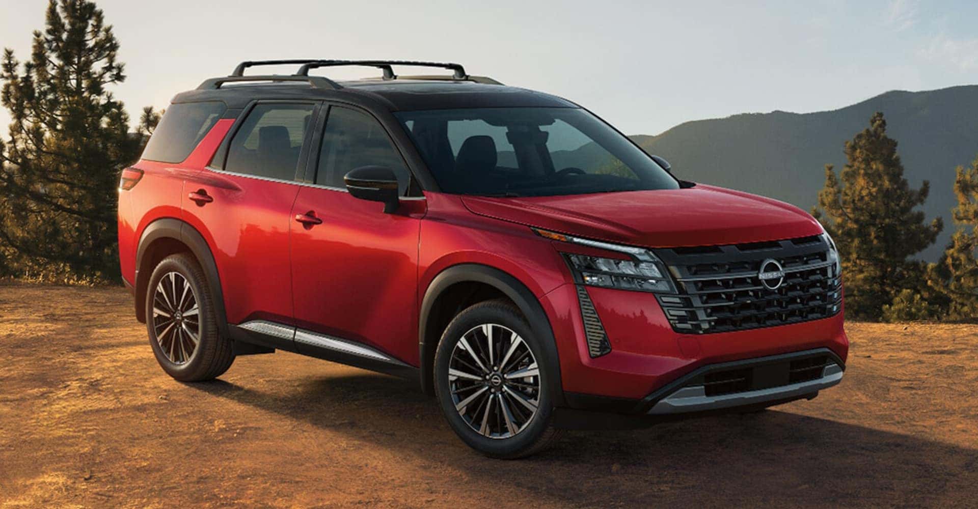 2026-nissan-pathfinder-front-three-quarter-view-red-exterior-mountain-terrain-lightbox-D