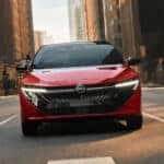 Front view 2026 Nissan Sentra red with headlights on
