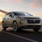 2026 Nissan Murano driving across bridge at sunset