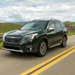green forester driving by field