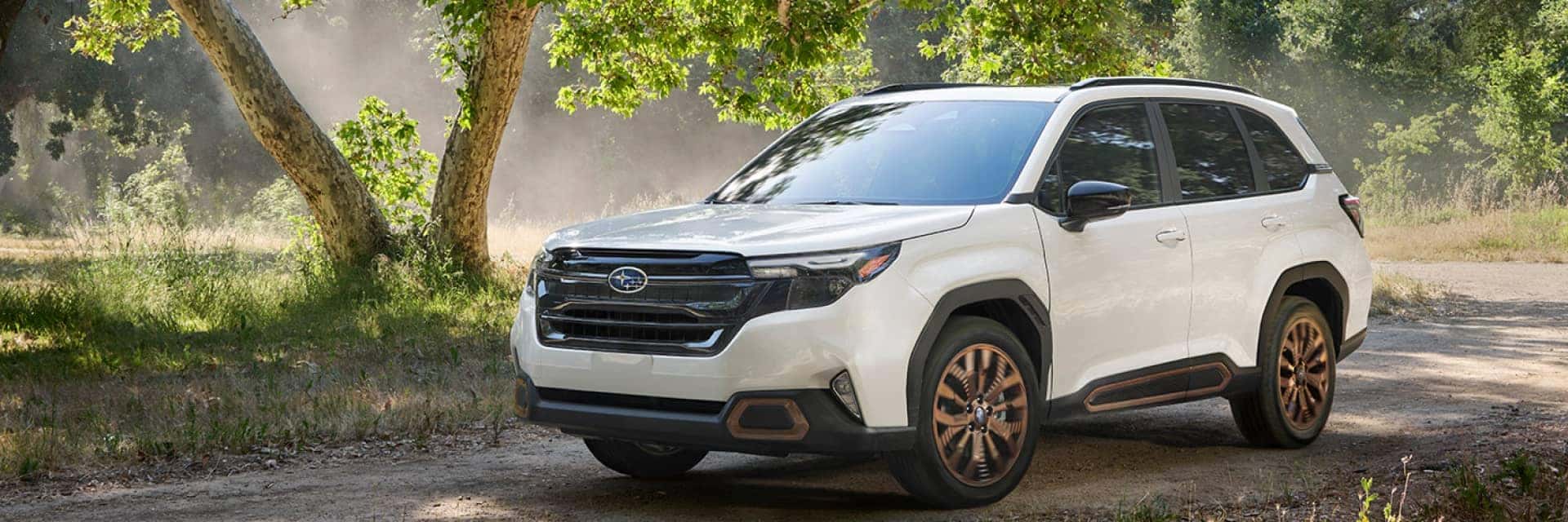 White 2025 Subaru Forester Sport with forest scenery