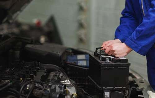 Mechanic Replacing Car Battery