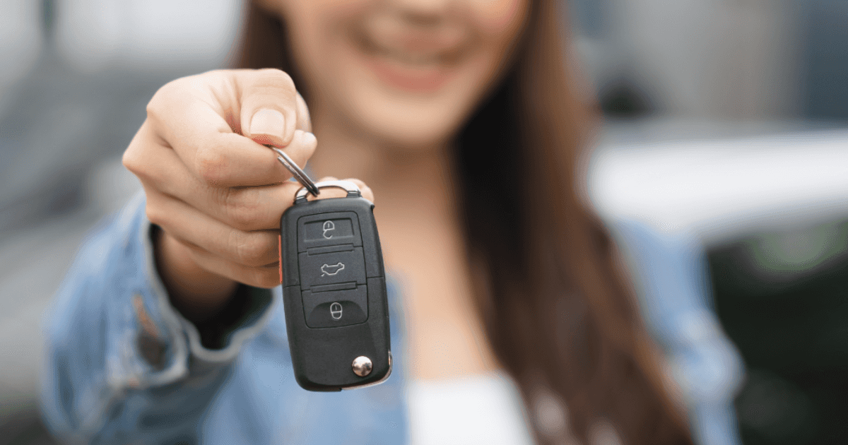 Smiling woman showing off the keys to her new Mitsubishi