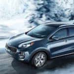 Kia Sportage driving on icy road in winter time