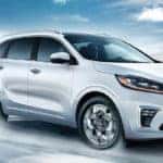White Kia Sorento driving on icy road in winter