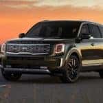 Kia Telluride on a desert road at dusk