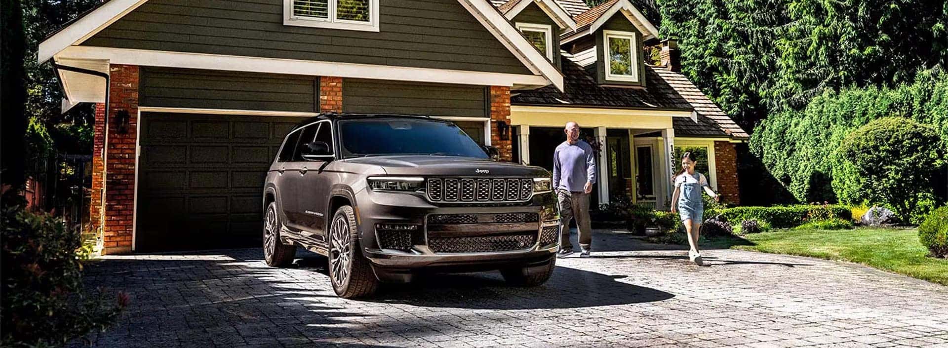 Jeep Grand Cherokee in front of house in the woods