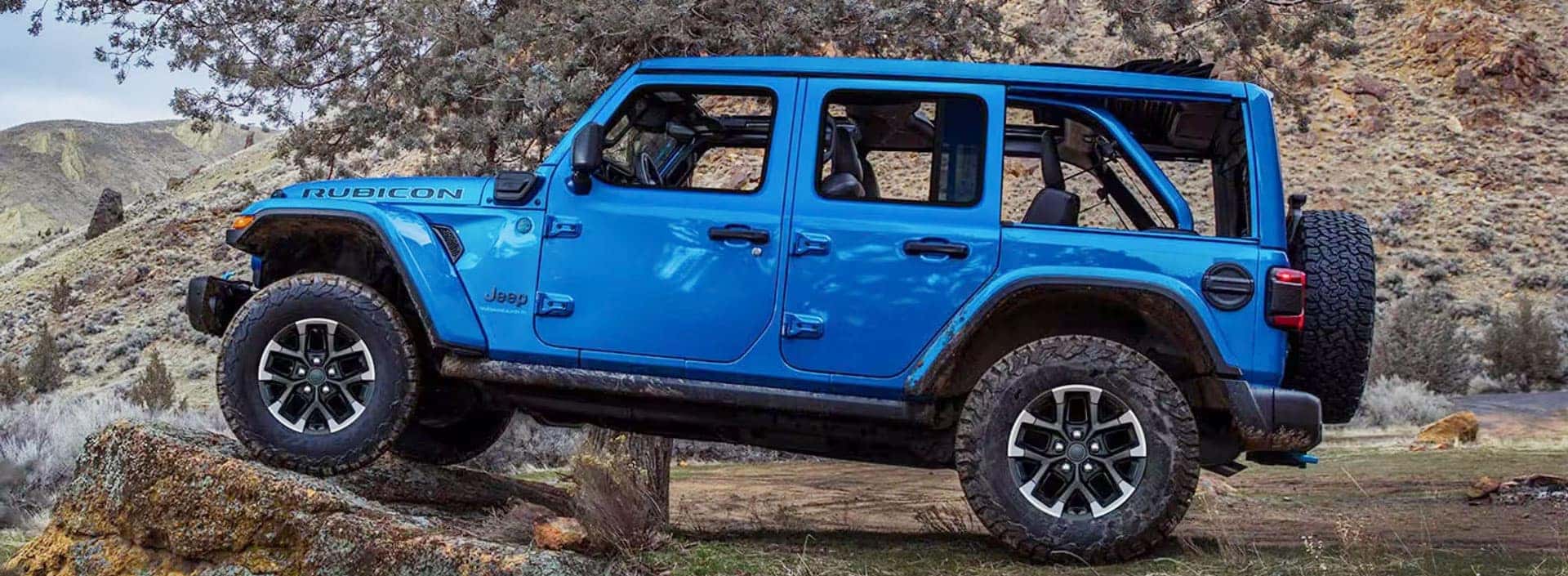 Jeep Wrangler 4xe driving up rock in mountains