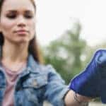 Woman using microfiber cloth to clean car windshield